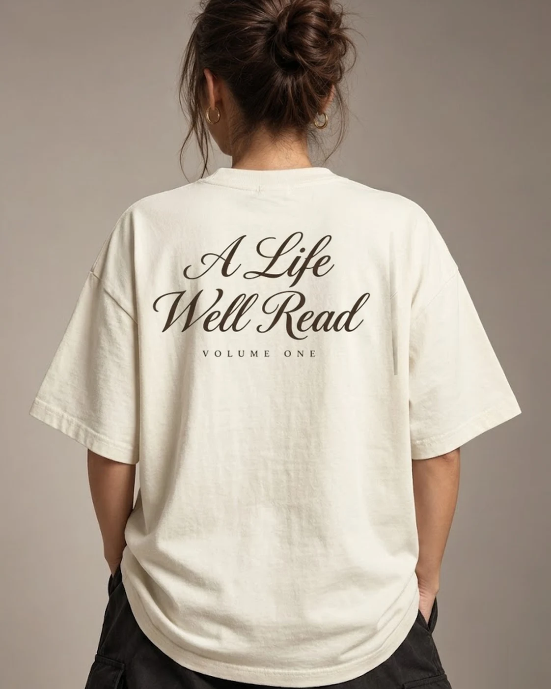 A Life Well Read cream oversized tee worn, back print view, styled