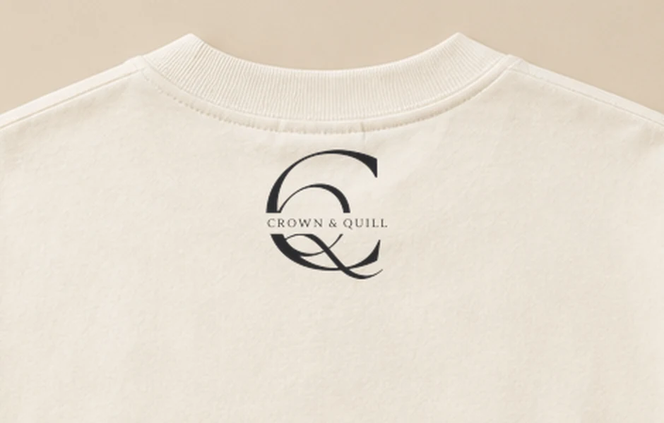 Close detail of the Crown & Quill monogram printed at the back neck